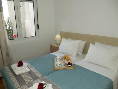 a bedroom with a bed with a tray of food on it at Brigitte house in Chania Town