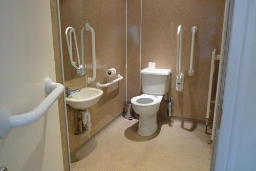 a bathroom with a toilet and a sink at Pentland Lodge House in Thurso