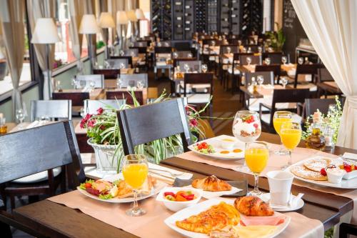 a table with plates of food and glasses of orange juice at Contarini Luxury Rooms in Split