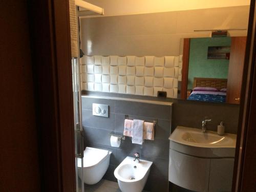 a bathroom with a sink and a toilet and a mirror at B&B Villa Maria in Montesilvano