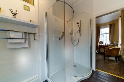 a bathroom with a shower with a glass door at The Gaydon in Lytham St Annes