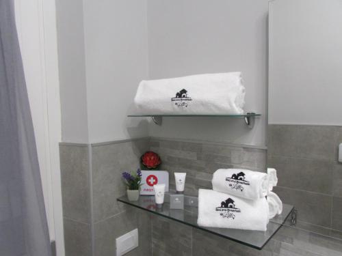 a bathroom with towels on a glass shelf at B&B da Lillo in Frosinone