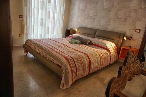 a bedroom with a large bed with two pillows on it at Le Note di Elisa in Naples