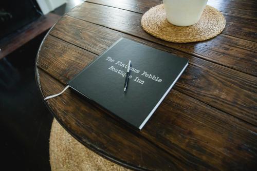a book sitting on top of a wooden table at The Platinum Pebble Boutique Inn - Adults Only Property in Harwich Port