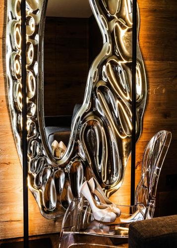 a mirror with a bunch of shoes in front of it at Hotel Lenderstuben in Balzhausen