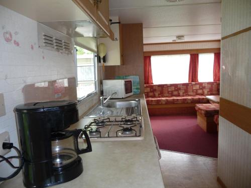 a kitchen with a stove and a counter top at Altogold Swiss Holidays At Manor Farm 5* in Interlaken