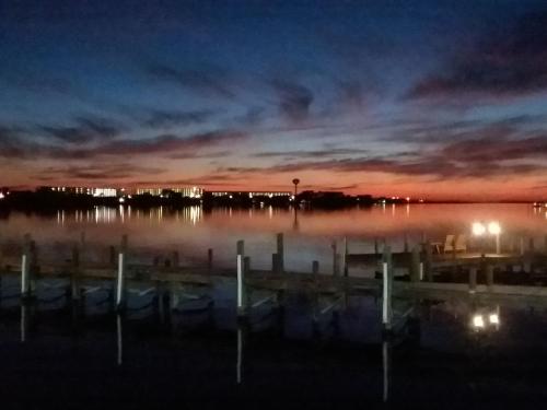 a body of water with a dock at night at Seabreeze Inn - Fort Walton in Fort Walton Beach