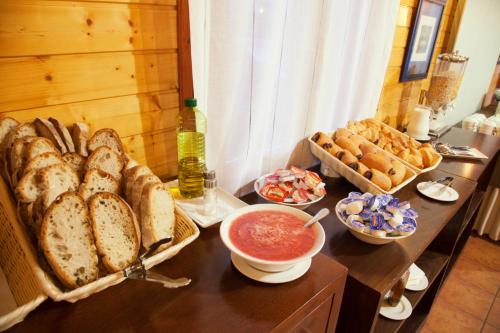 a table topped with lots of different types of bread at Alda Palas de Rei in Palas de Rei