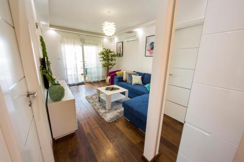 a living room with a blue couch and a table at Apartment Tina in Split