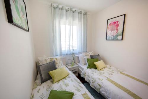 a bedroom with two beds and a window at Apartment Tina in Split