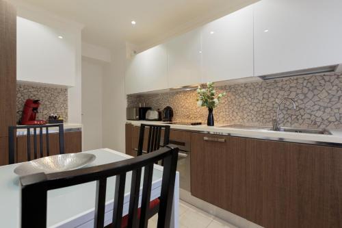 a kitchen with a sink and a counter top at The Queen Luxury Apartments - Villa Carlotta in Luxembourg