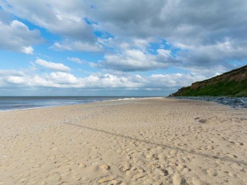 a beach with footprints in the sand and the ocean at Sunbeach Chalets in Great Yarmouth