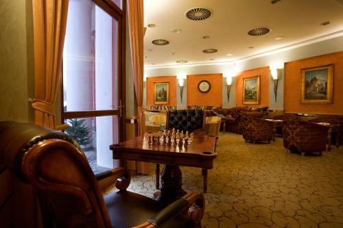 a room with a chess board on a table at Hotel Ambiente Wellness & Spa in Karlovy Vary