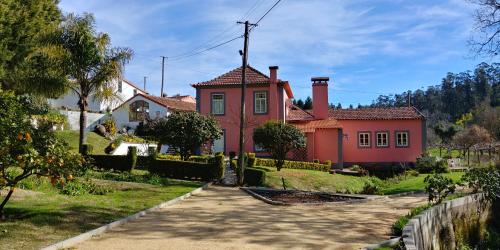 a large red house with a driveway in front of it at Quinta das Águias in Aveiro