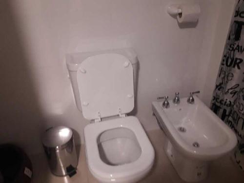 a bathroom with a white toilet and a sink at Estudio 9 de Julio in San Miguel de Tucumán
