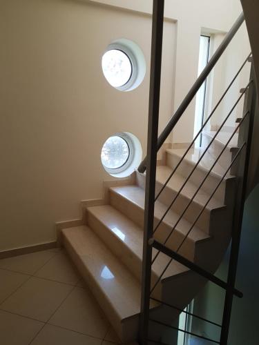 a staircase with two windows in a house at Christina´s Beachside Apartment in Rio