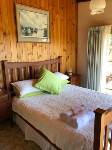 a bedroom with a bed with two towels on it at Rose Cottage in Metung