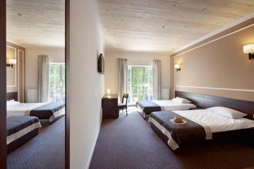 Ένα ή περισσότερα κρεβάτια σε δωμάτιο στο Geneva Resort Hotel