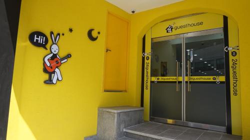 a building with a mural of a rabbit playing a guitar at 24 Guesthouse Jeonju in Jeonju