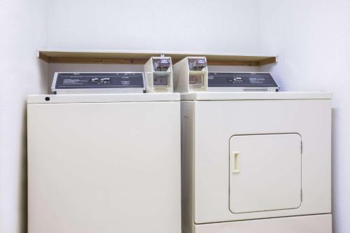 two appliances sitting on top of a refrigerator at Super 8 by Wyndham Sweet Springs in Sweet Springs