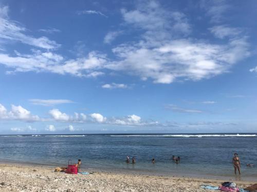 a group of people in the water at the beach at ti Kaz Papang in La Plaine des Cafres