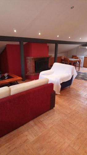 a room with a bed and a couch and a fireplace at Four Seasons Hotel in Trílofon