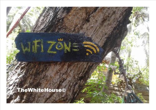 a sign on the side of a tree at The White House in Trincomalee