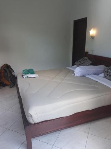 a large bed sitting in a room with at Sugi Gede Homestay in Singaraja