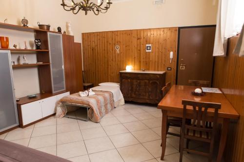 マテーラにあるIl Giardinettoのベッド、デスク、テーブルが備わる客室です。