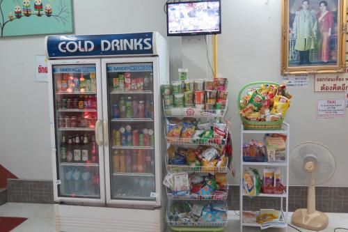a cold drink cooler in a store with food and drinks at Nadpob Mansion in Surat Thani
