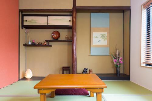 a room with a table and a shelf at Kyonomachi Hakuho in Kyoto