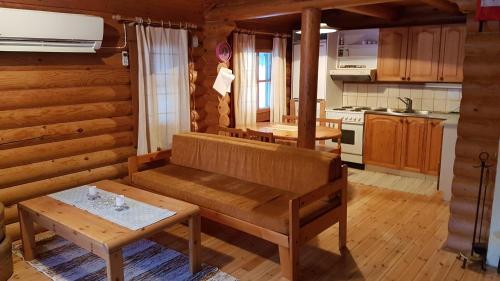 a kitchen with a bench and a table in a room at Kalajärven Lomakylä in Peräseinäjoki