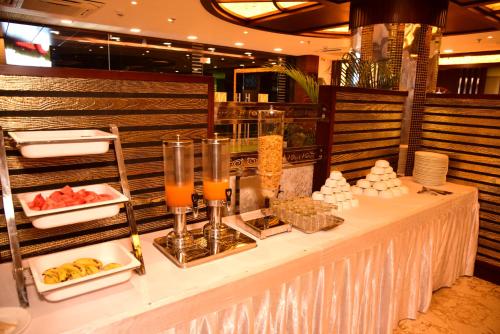 a buffet table with food and drinks on it at Hotel Varanasi Inn in Varanasi