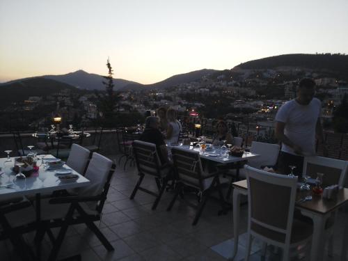 a group of people sitting at tables on a roof at Enda Boutique Hotel Kalkan in Kalkan