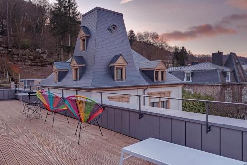 a house with two chairs and a table on a deck at Vistay apartments in Luxembourg