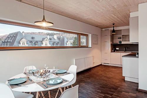a dining room with a table and chairs and a window at Vistay apartments in Luxembourg