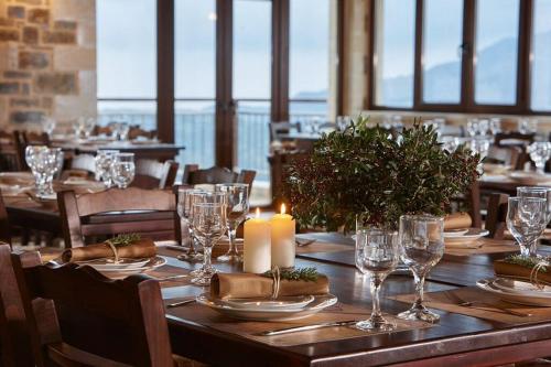 a table in a restaurant with a candle on it at Archontiko Manias in Axós