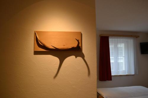 a picture of a whale on a wall next to a window at B&B Chasa Arfusch in Ardez
