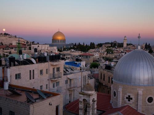 a view of the city of jerusalem at sunset at Dan Boutique Hotel Jerusalem in Jerusalem