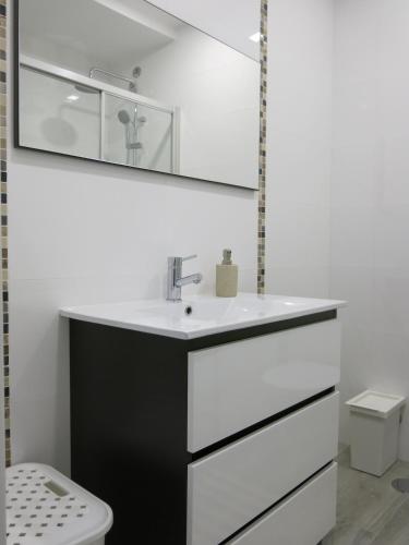a bathroom with a sink and a toilet at Serena Beach 2 in Nazaré