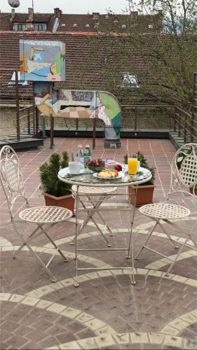 a table and chairs with a plate of food on it at Art 'Otel in Sofia