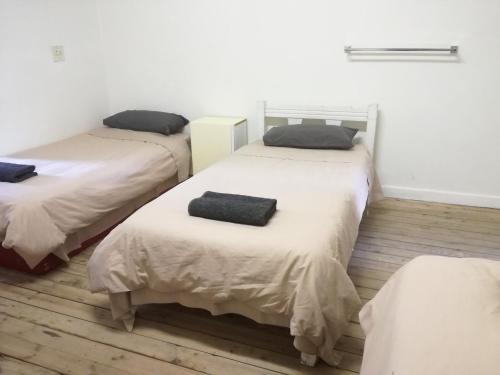 Ένα ή περισσότερα κρεβάτια σε δωμάτιο στο Paarl Backpackers