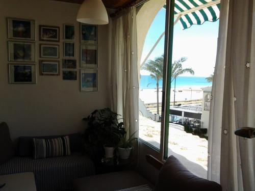a living room with a view of the beach at Al Andalus, Playa de Muchavista in El Campello