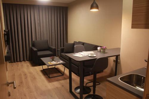 a small room with a table and chairs and a kitchen at Endless Comfort Hotel Taksim in Istanbul