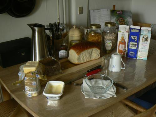 a counter top with bread and other ingredients on it at Aakirkeby Bed and Breakfast in Åkirkeby