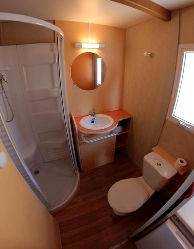 a small bathroom with a toilet and a sink at Camping Roca Grossa in Calella
