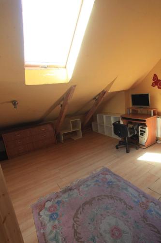 an attic room with a desk and a computer in it at Schronisko młodzieżowe w Jabłonkach in Jabłonki