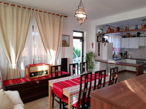 a kitchen and dining room with a table and chairs at Agropensiunea Ioana in Suceava