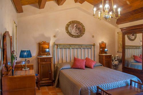 a bedroom with a bed with red pillows on it at Villarose in Castelbuono