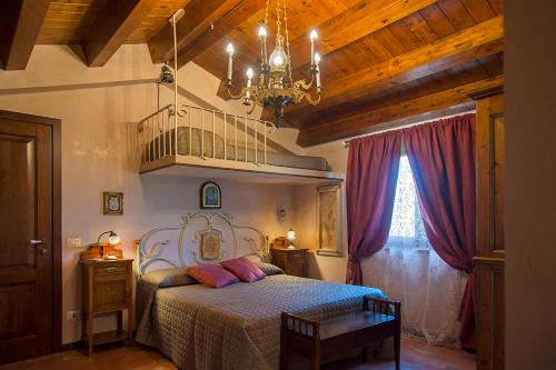 a bedroom with a bed and a chandelier at Villarose in Castelbuono